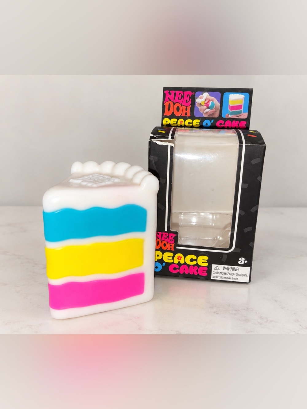 NeeDoh Peace O' Cake Squishy Toy - White with Blue, Yellow, Pink Accents
